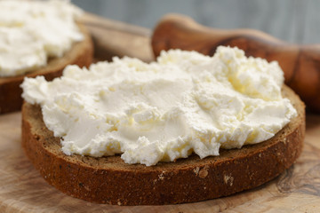 rye bread with cream cheese on wood table