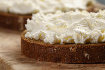 rye bread with cream cheese on wood table