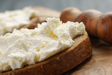 Fototapeta na wymiar rye bread with cream cheese on wood table