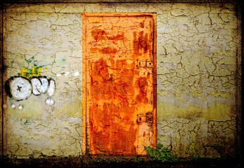Rusted metallic door and scratched wall