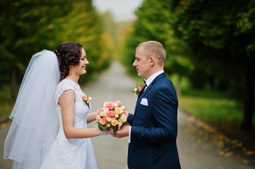 wedding couple walking at green park
