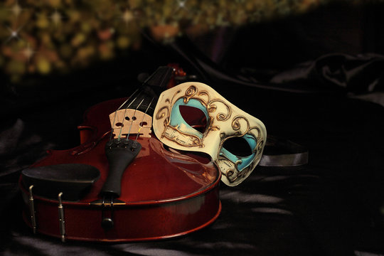 Venetian mask and a violin on a dark background