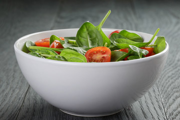 fresh summer organic salad with tomatoes cucumbers and spinach