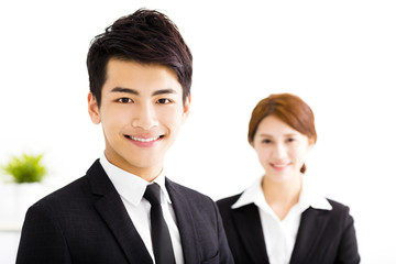 happy business man and woman standing  in office