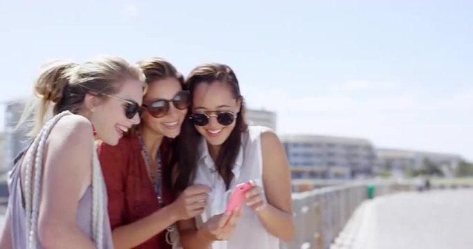 Group of Teenage girls taking photo using mobile phone at beach on summer vacation  close up