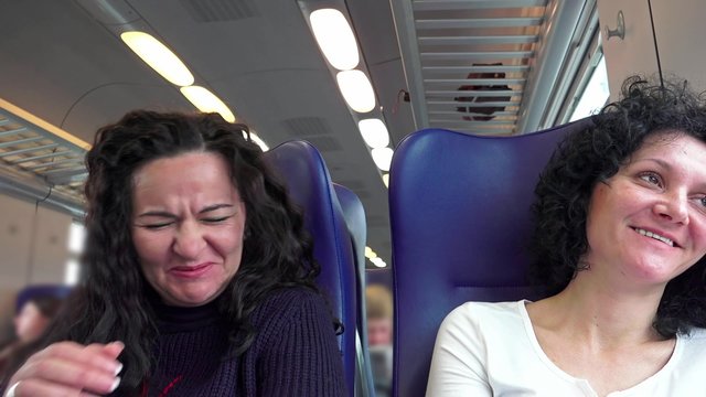 Two Woman Riding A Train Moving, They Laugh Talking Adventures. UHD 4K stock footage