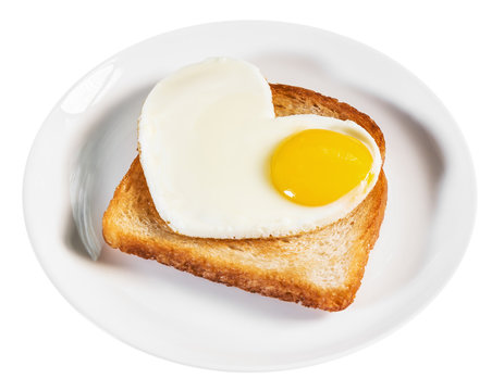 heart-shaped fried eggs and fried toast isolated