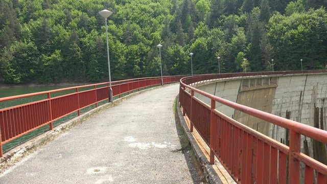 Engineer walking over dam arc crawn pov. Structure security checkup. UHD 4K steadycam pov