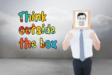 Composite image of businessman with photo box on head