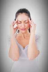 Fototapeta premium Composite image of brunette suffering from migraine 