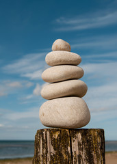 Pile of beautifully stacked stones with sea horizon in background. 