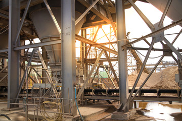 LONDON, UK - MAY 4, 2015: Industrial site at the River Thames. Cement supply. Containers against of sunset light