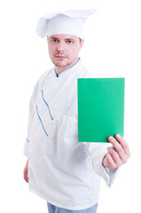 Chef or cook holding green paper card with copy space