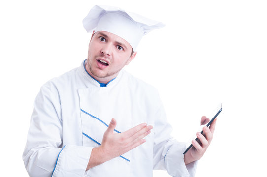 Shocked and outraged chef or cook holding a tablet