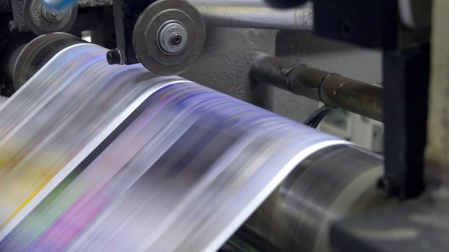 Web set offset print shop newspapers Printing, Newspapers coming off the rotation printing press industrial machine. UHD steadycam 4K stock footage