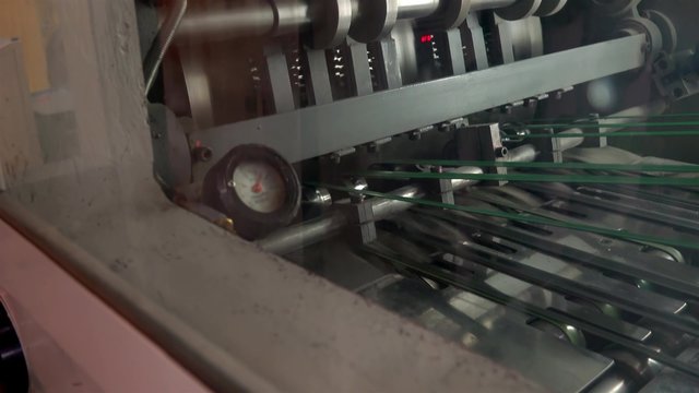 Web set offset print shop newspapers Printing, Newspapers coming off the rotation printing folder in press industrial machine. UHD 4K steadycam stock footage