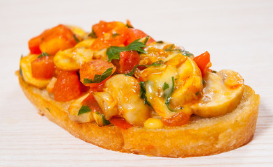 tomato bruschetta with chopped vegetables, herbs, cheese and mushroom on toasted crusty ciabatta bread