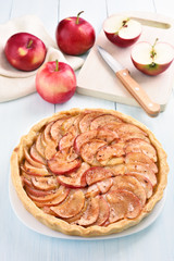 Fruit pie with fresh apples on wooden table