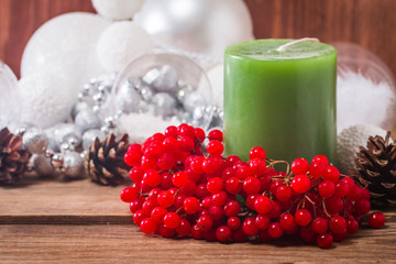 Christmas composition with candles and viburnum