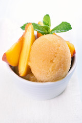 Scoop of peach ice cream with mint