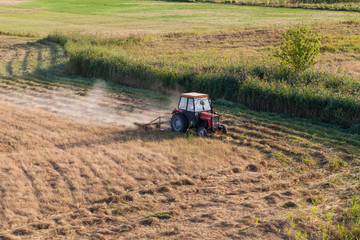aerial view of harvest fields with tractor in Poland