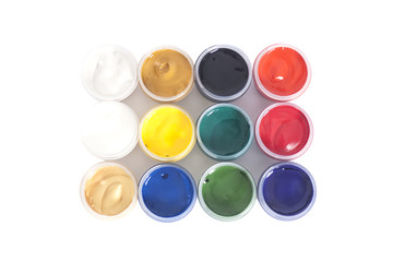 Open colorful cans of gouache paint isolated on white