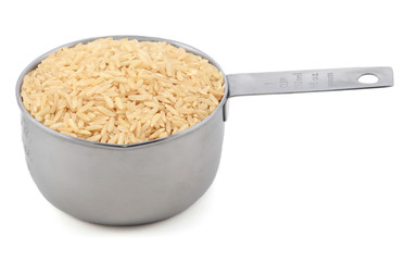 Long grain brown rice in a measuring cup