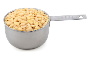 Pine nuts in a measuring cup
