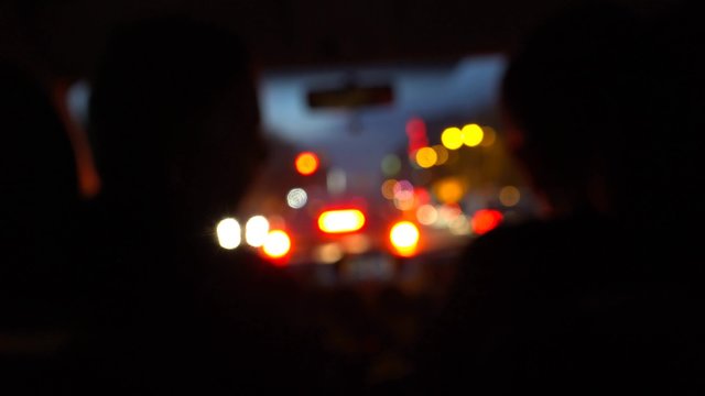 Car driving at night blurred with illuminated dashboard and navigation, POV UHD 4K stock footage