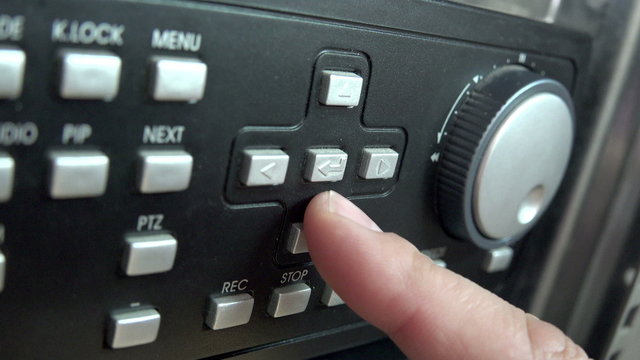 4K Security personnel operates dvr and watching the screens in a system control center close up. UHD surveillance facility stock footage