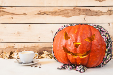 Halloween.  Carved pumpkin in bandana on a wooden background 