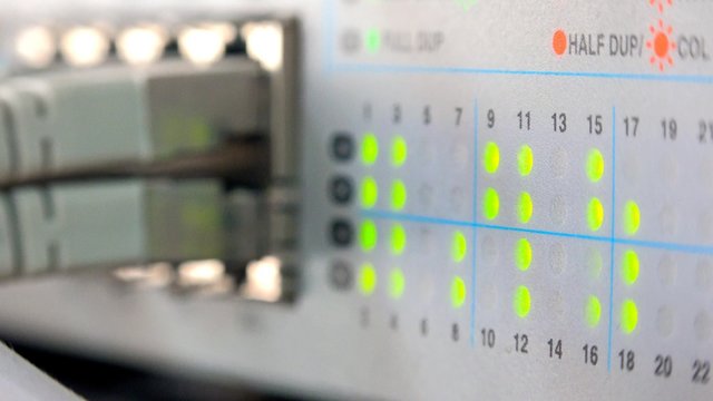 4k Lights snow internet connection activity on working network switch side view closeup. UHD stock footage