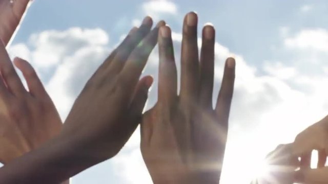 Hands reaching for sun solar energy concept