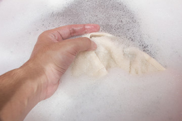 Hand washing clothes with soapy water