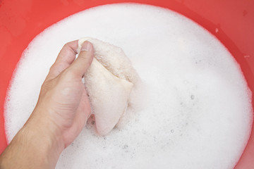 Hand washing clothes with soapy water