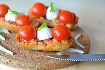 Italian Bruschetta With Mozzarella And Tomato On A Wooden Table