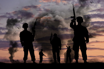 Silhouettes of military soldiers with guns