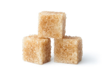 Brown cane sugar cubes isolated on white background