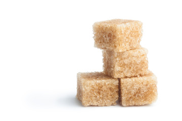 Brown cane sugar cubes isolated on white background