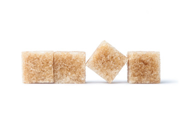 Brown cane sugar cubes isolated on white background