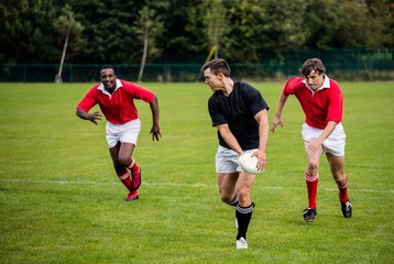 Obraz na płótnie Canvas Rugby players running during game