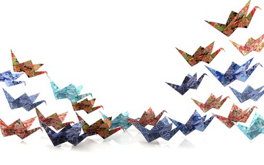 Group of Origami paper birds taking off, freedom concept