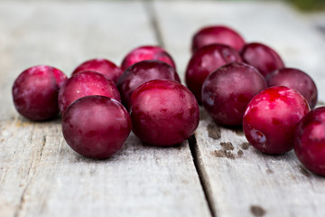 Sweet plums on wooden background
