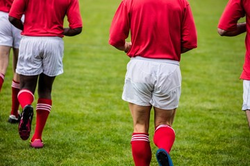 Fototapeta premium Rugby players jogging with ball
