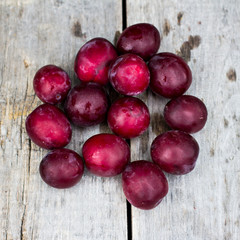 Sweet plums on wooden background