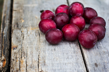 Sweet plums on wooden background