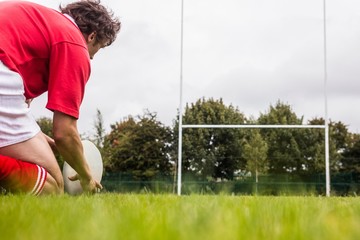 Rugby player getting ready to kick ball © WavebreakmediaMicro