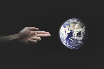 Human Hand Shooting the World. Environment concept. World Environment Day concept. - Elements of this image furnished by NASA.