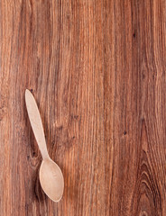 white wooden spoon on the wooden background