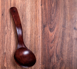 red wooden spoon on the wooden background